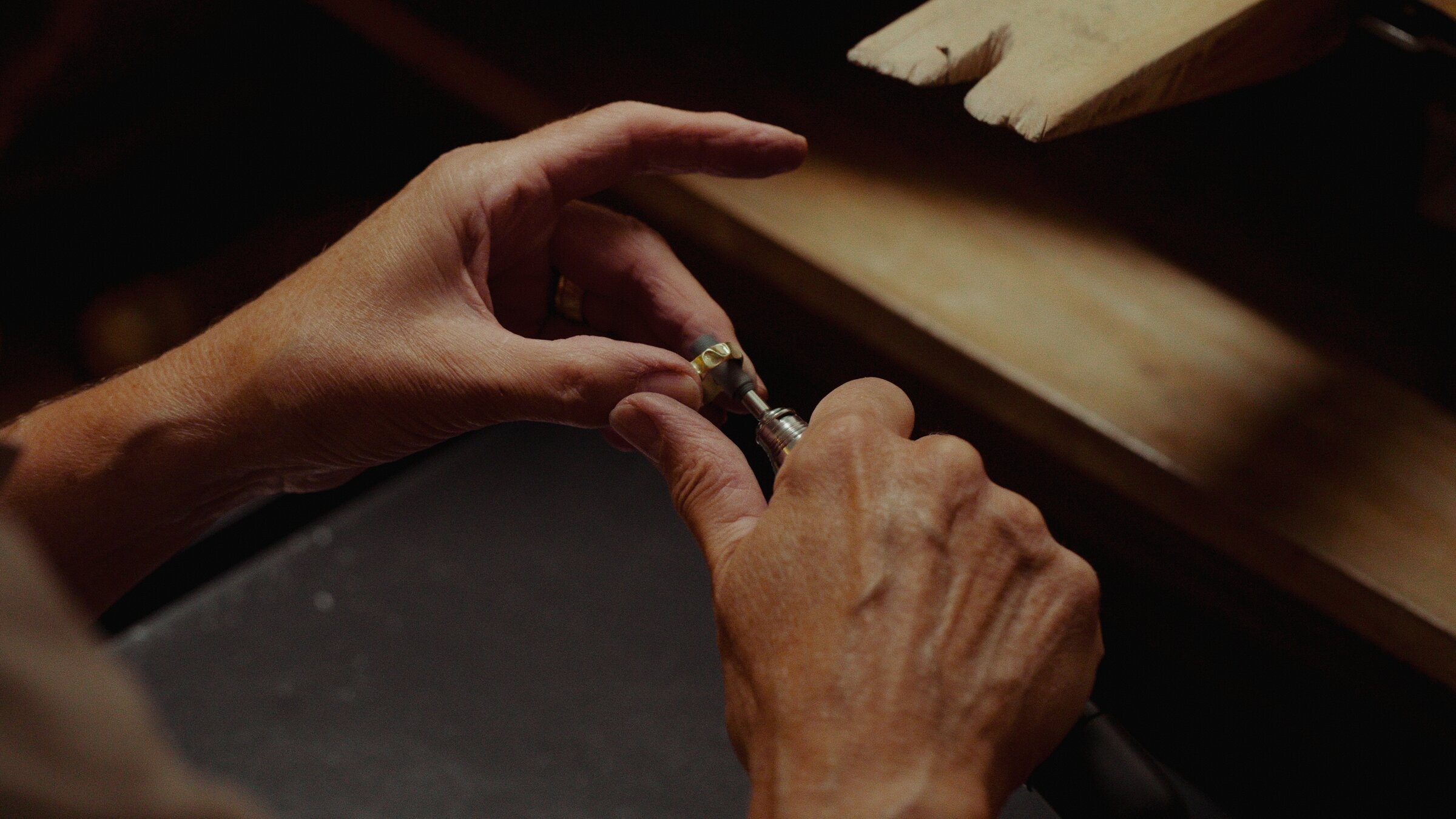 Polishing a ring with a rotary tool at the bench