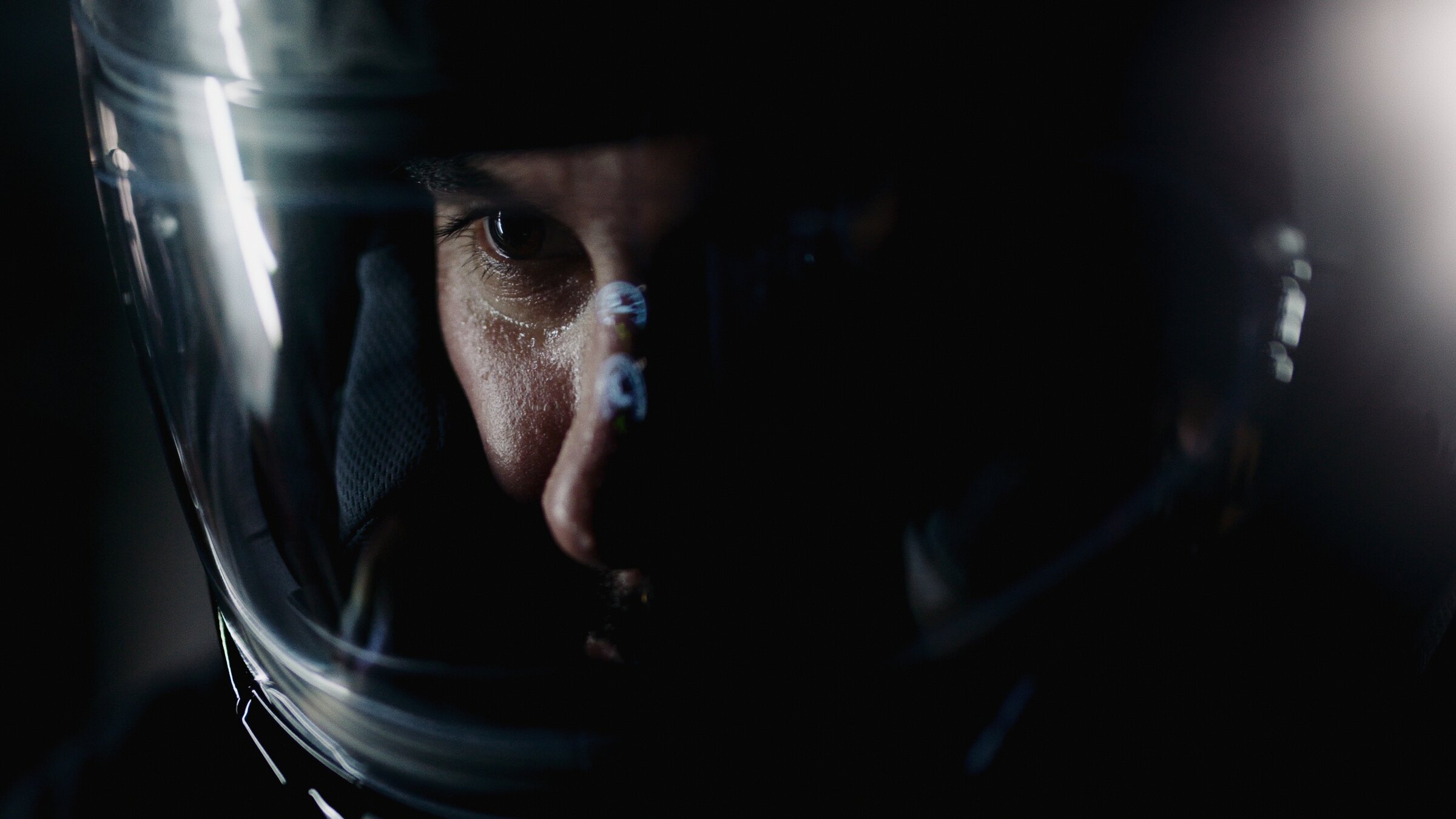 Rider portrait through a helmet visor, close on the eyes